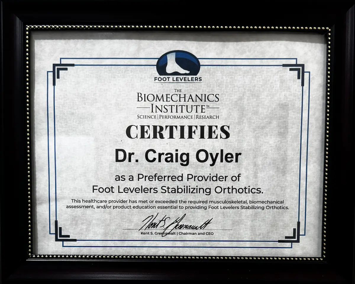 A framed certificate from The Biomechanics Institute certifying Dr. Craig Oyler as a Preferred Provider of Foot Levelers Stabilizing Orthotics.